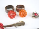 three rings and a pair of hair clips on a table