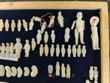a lot of figurines displayed in a display case