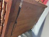 a wooden table with a metal handle hanging from it ' s side