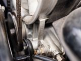 a close up of a motorcycle engine with a chain attached to it