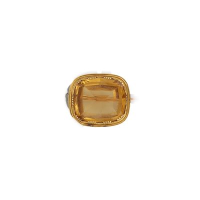 Gros plan sur une bague contenant une pierre jaune