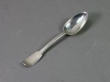 a silver spoon with a spoon handle on a table
