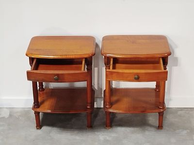 pair of antique end tables with drawers on each side of them