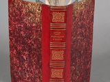 a red book that is open on a gray surface