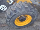 a yellow wheel on the back of a construction vehicle