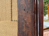 a close up of a chair with a wooden frame on it
