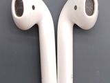 two airpods that are sitting side by side on a table