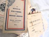 une pile de vieux livres posée sur un lit recouvert de draps