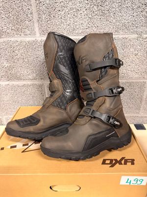 the boots are sitting on a box in front of a brick wall