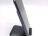 a cell phone that is sitting on top of a stand