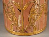 a close up of a vase with a bird on it