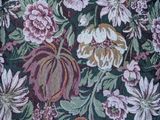 a close up of a bed with a floral comforter on it