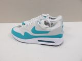 the nike air max is a white and blue shoe with a light blue sole