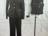 a mannequin in front of a suit and jacket on a stand