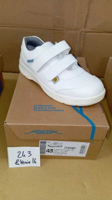 a box with a pair of shoes on it and a pair of shoes on the box