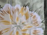 a picture of a close up of a piece of fabric with a flower on it