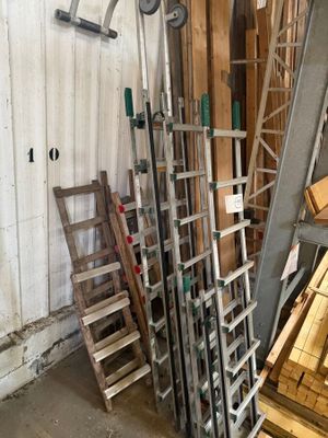 many pieces of wood stacked on top of each other in a room