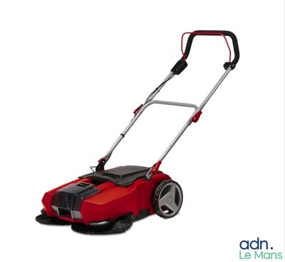 a red lawn mower sitting on top of a white surface