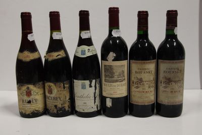 six bottles of wine are lined up in a row on a table