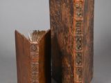 two old books sitting next to each other on a table