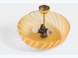 yellow glass bowl with a light on top of it on a white surface