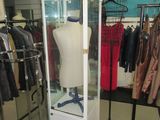 a display case with a mannequin in it in a clothing store