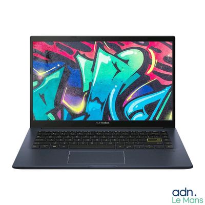the laptop is open on a white surface with graffiti on the screen
