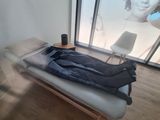 a person laying on a bed in a room with large windows