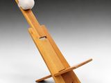 a wooden chair with a roll of toilet paper on top of it
