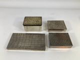 three silverplated boxes and a silverplated box on a white surface