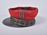 a red hat with a metal band around the brim