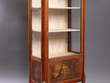 an antique wooden display cabinet with a glass door and shelves