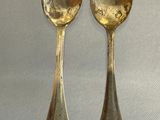 two spoons that are sitting on a table