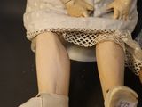 a doll that is sitting on a black surface