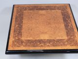 a close up of a wooden table with a square design on it
