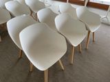 many white chairs sitting in a row in a room