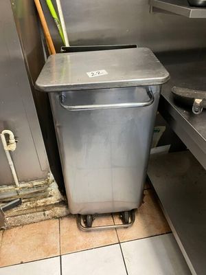 a trash can sitting in the middle of a kitchen