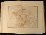 an open book with a map of france on it on a black surface
