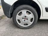 a white car with a flat tire on the street