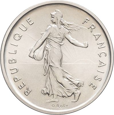 the coin is silver and has a woman walking on it
