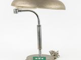 an image of a desk lamp with a green base on a white background