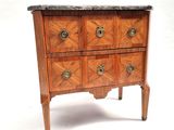 a small chest of drawers with a marble top