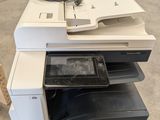a white and black printer sitting on top of a wooden table