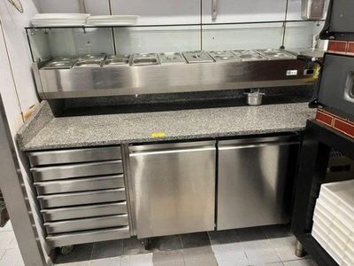 a kitchen that has a lot of stainless steel appliances in it