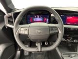 the interior of a car with a steering wheel and dashboard controls