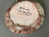 a close up of a piece of pottery with writing on it