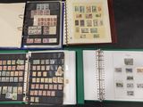 many different types of stamps in a binder on a table