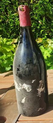 a bottle of wine sitting on a wooden table