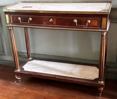 a small table with a marble top on a hard wood floor