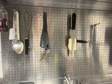 many utensils hanging on the wall in the kitchen